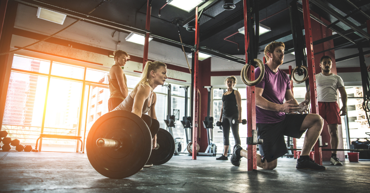 Group of people stretching together during a fitness warm-up session